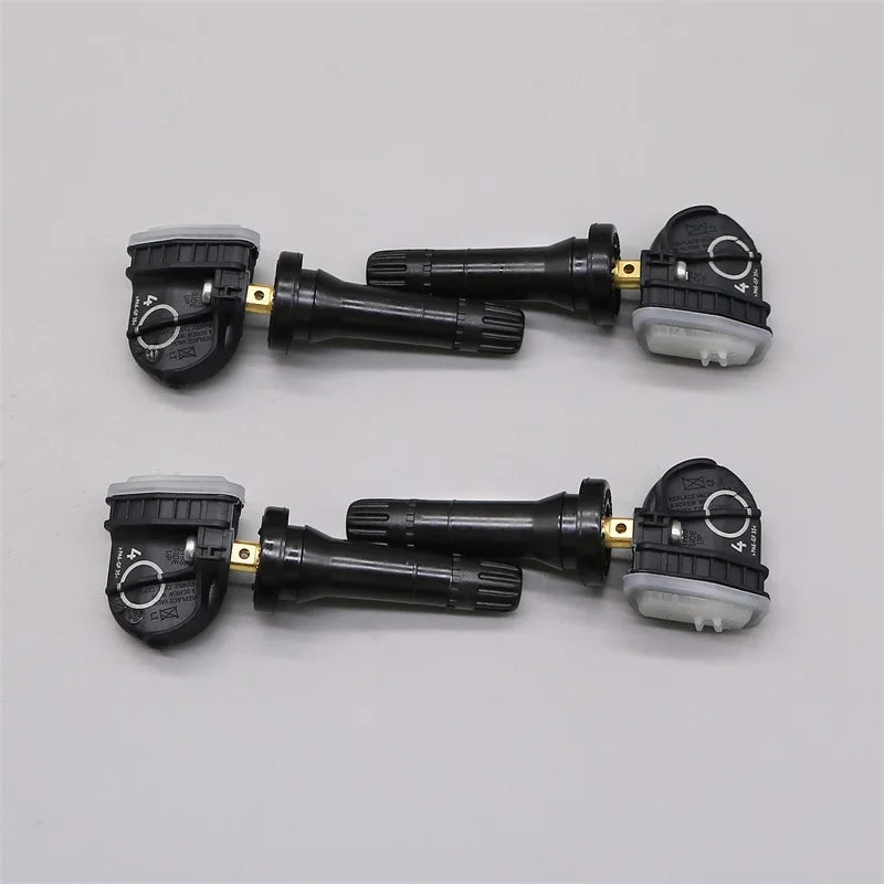 Four black tire pressure monitoring system sensors for vehicle safety and maintenance — view 2