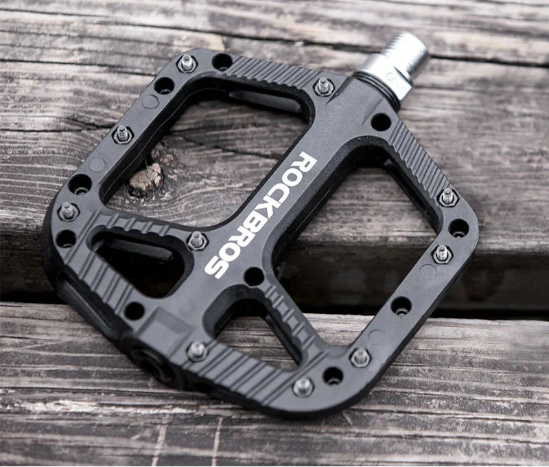 Black ultralight flat platform bicycle pedals made of nylon composite with anti-skid traction pins — view 2
