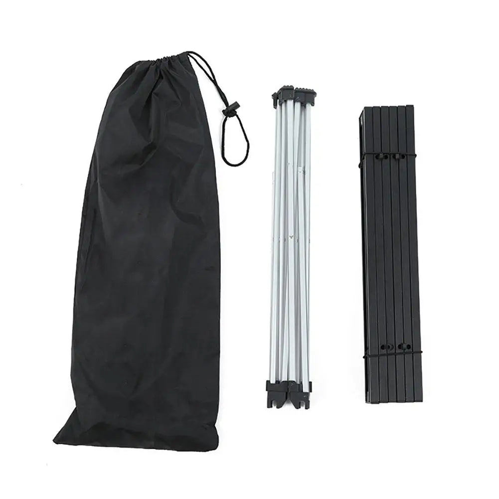 Portable aluminum camping table in silver with black folding bracket and black travel storage bag — view 3