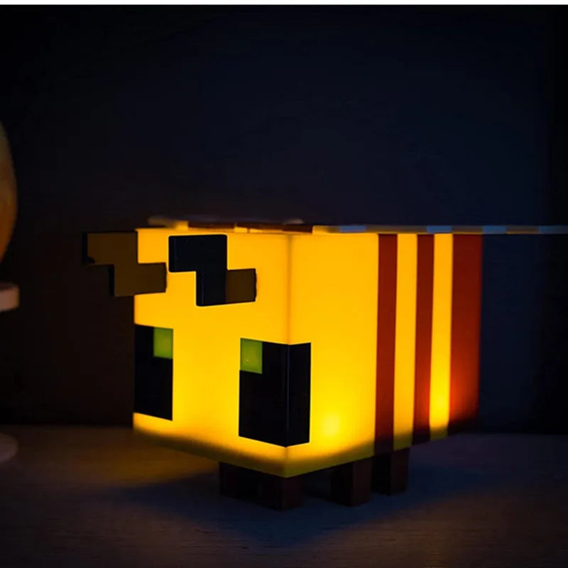Creative bee night light illuminating a soft LED glow on a child's bedroom bedside table — view 2