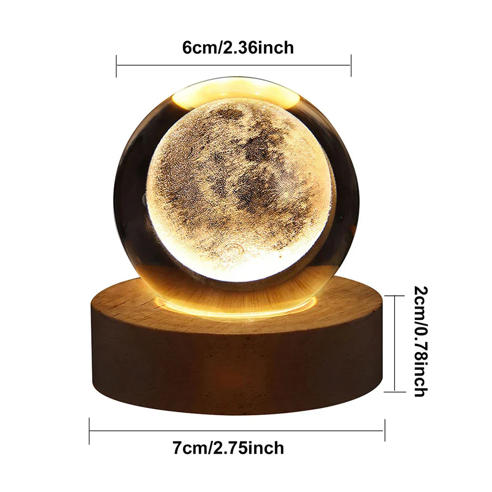 3D laser engraved galaxy crystal ball glowing on a warm LED illuminated wooden base — view 3