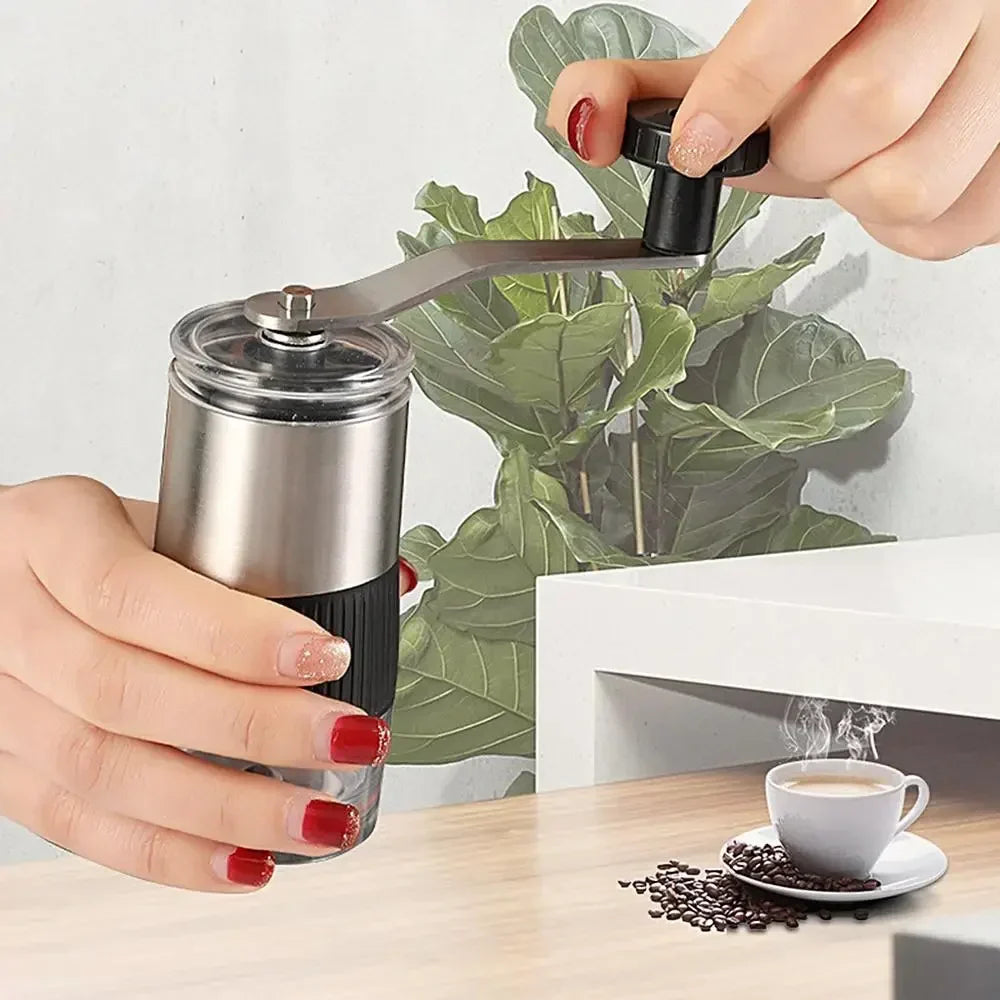Black manual coffee grinder with hand crank, adjustable ceramic burr, and silicone base — view 2