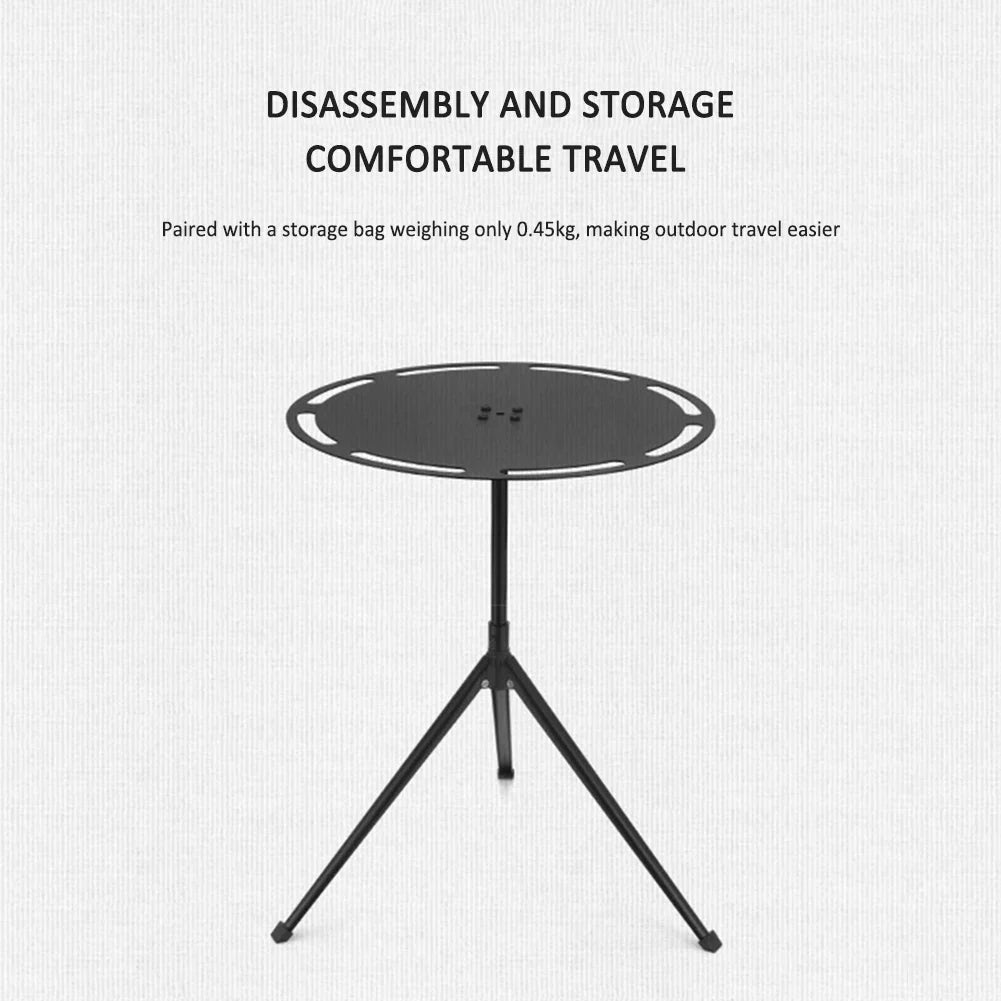 Portable round camping table with telescopic light pole and tripod base on outdoor terrain — view 2