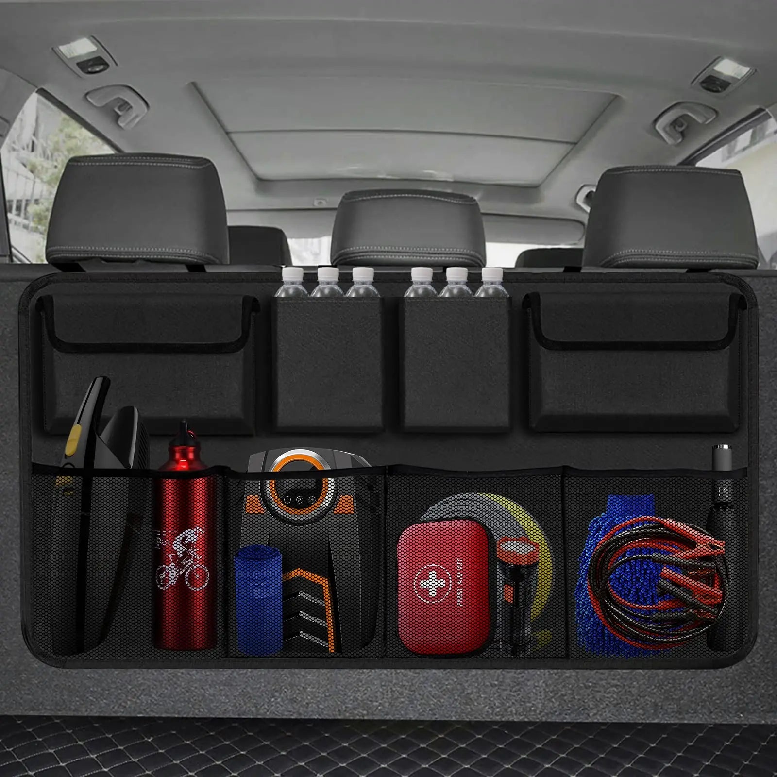 Black hanging car trunk organizer with 8 large storage pockets attached to vehicle backseat headrests — view 2