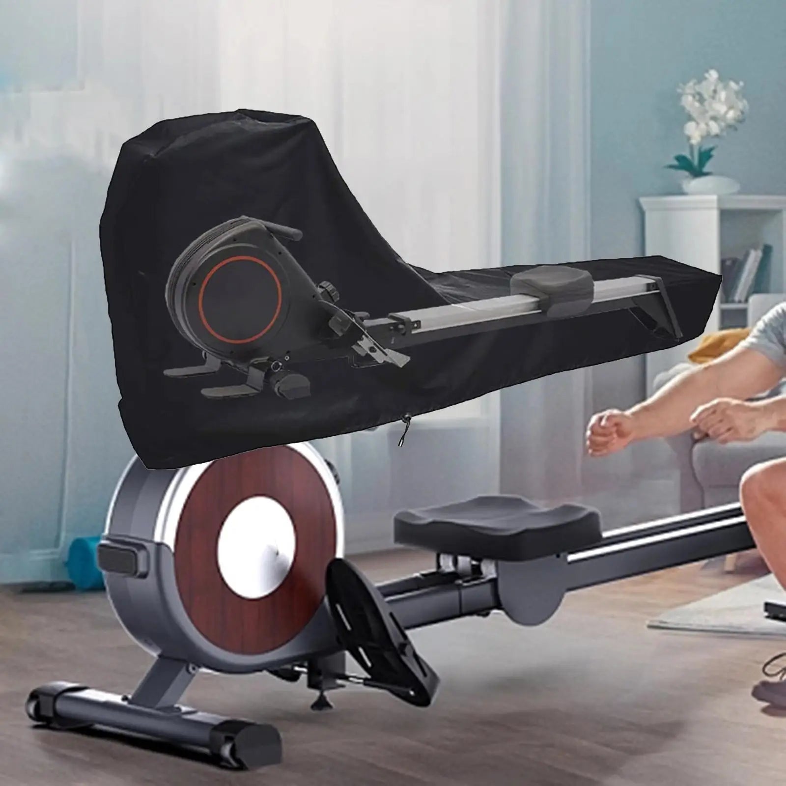 Black universal rowing machine cover with drawstring closure securely fitted over an indoor fitness rower — view 3