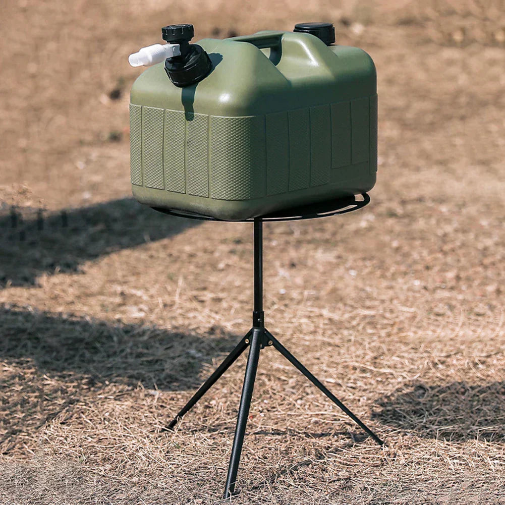 Portable round camping table with telescopic light pole and tripod base on outdoor terrain — view 3