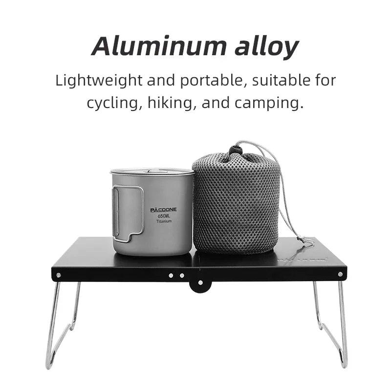 Black portable foldable camping table made of lightweight MDF, set up outdoors — view 2