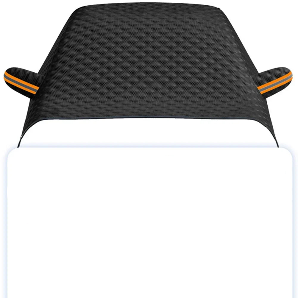 Black magnetic car windshield cover with reflective strips attached to a vehicle in the snow