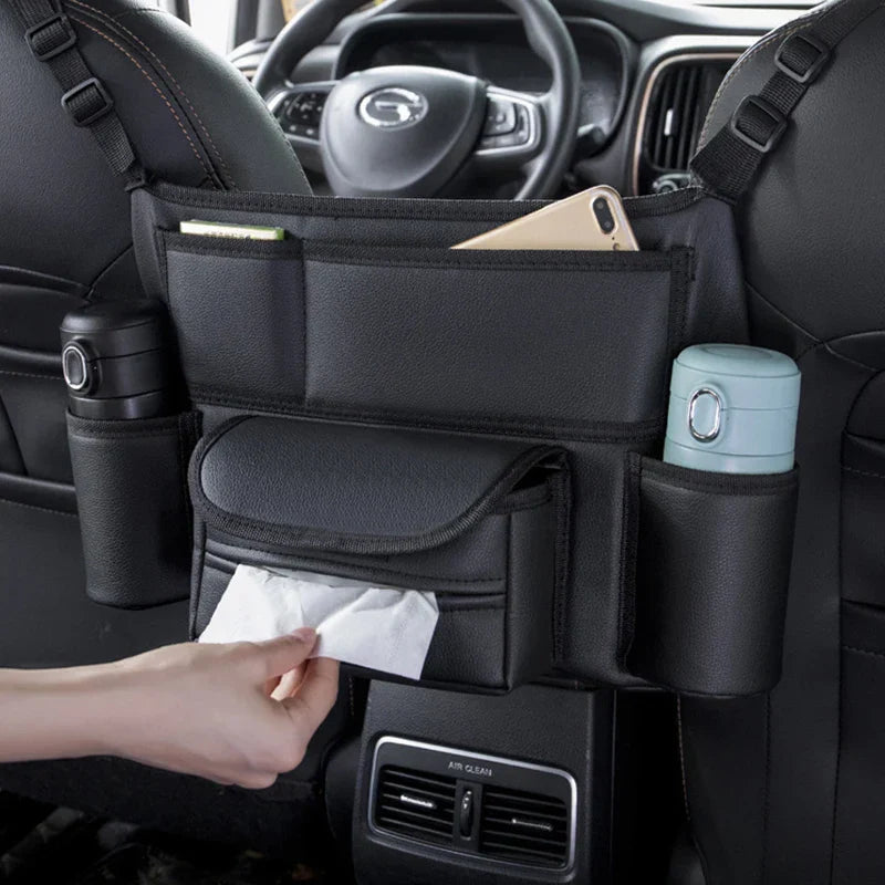 Black leather car seat storage bag hanging between front seats holding a handbag — view 4