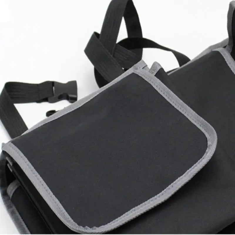 Black polyester car back seat organizer with multiple storage pockets hanging on a front seat — view 4