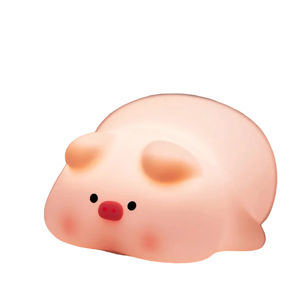 Cute pig night light made of soft white silicone emitting a warm glow on a desk
