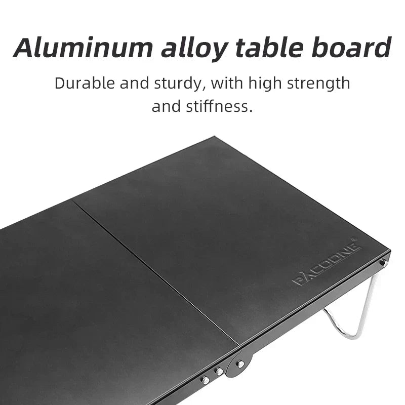 Black portable foldable camping table made of lightweight MDF, set up outdoors — view 3