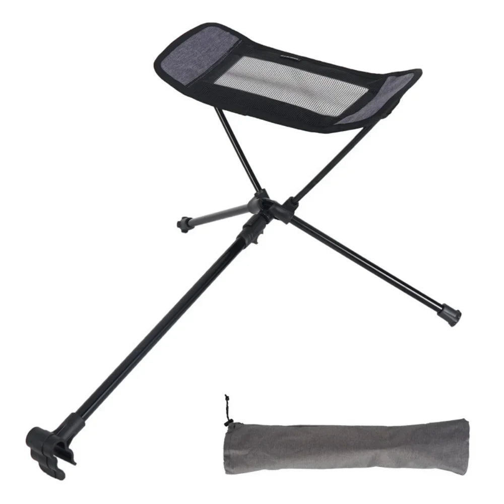 Lightweight folding outdoor camping chair with foot recliner and aluminum frame in outdoor setting