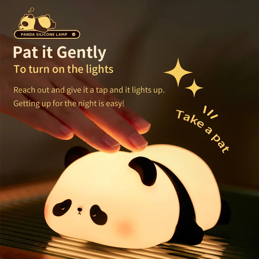 Cute panda silicone LED night light emitting a warm glow on a bedside table — view 4