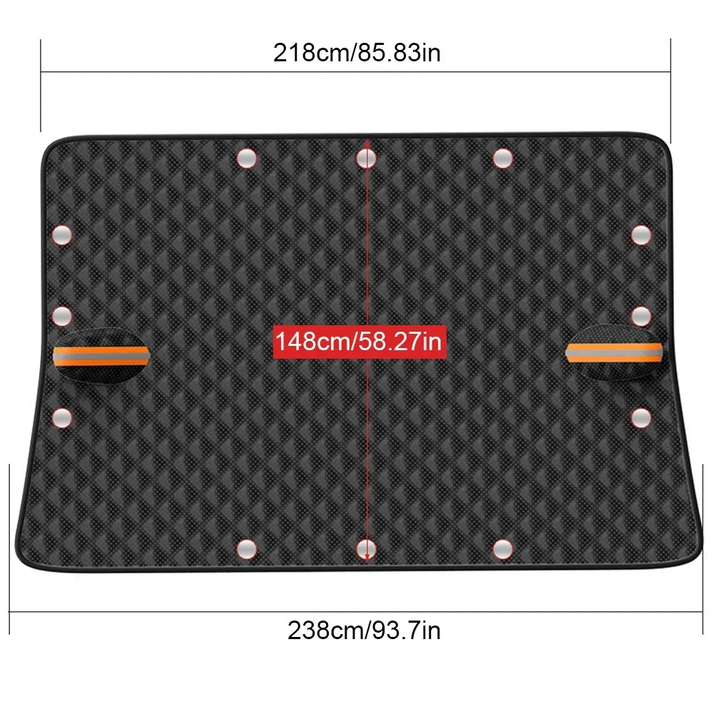Black magnetic car windshield cover with reflective strips attached to a vehicle in the snow — view 2