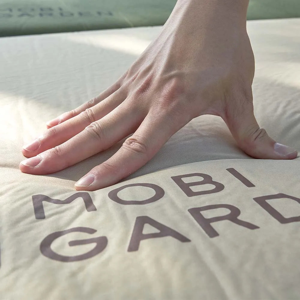 Brown single inflatable camping mattress pad with a thick foam core for outdoor tent setups — view 4