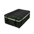 Black waterproof car roof cargo bag strapped to vehicle rooftop with reflective safety strips