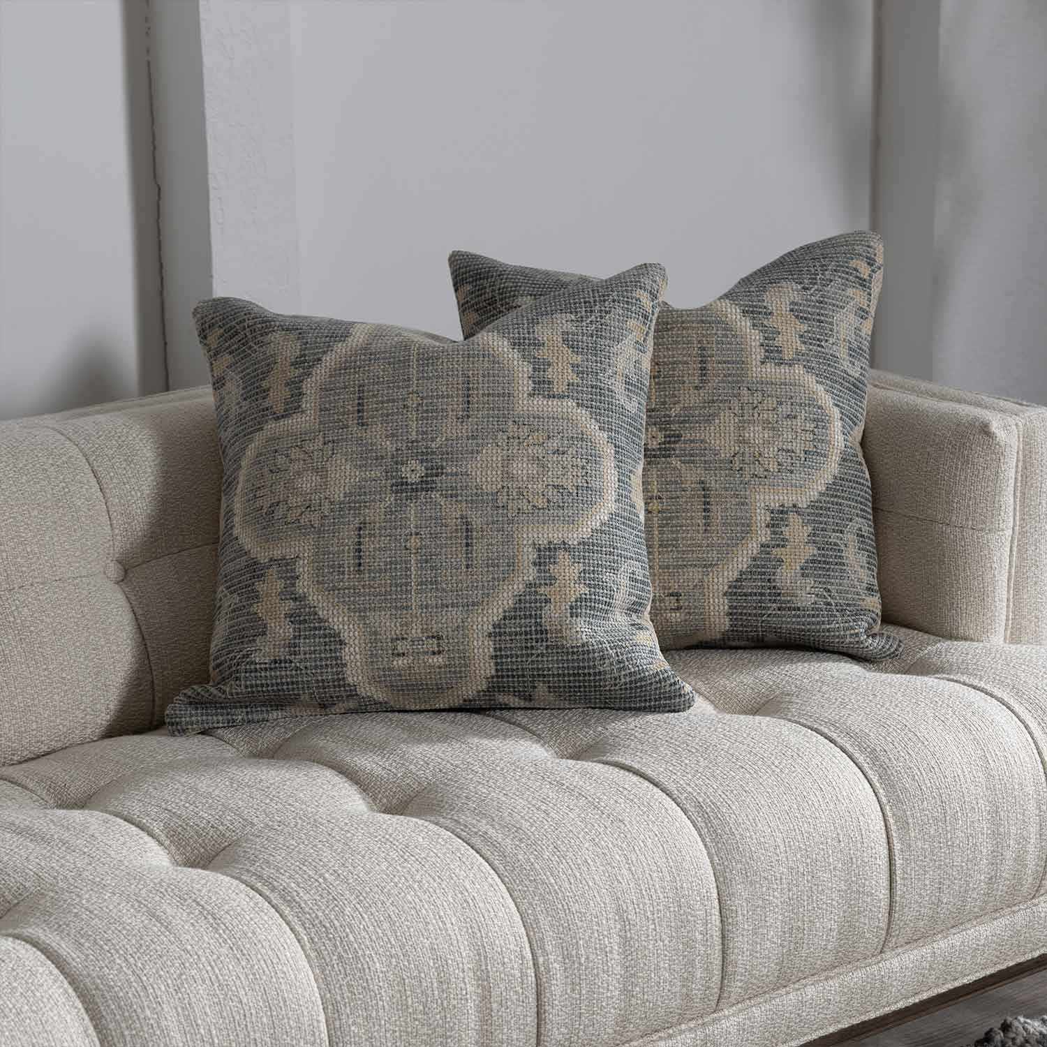 Woven Bigaa throw pillow cover in teal, gray, and peach traditional pattern on a sofa — view 5