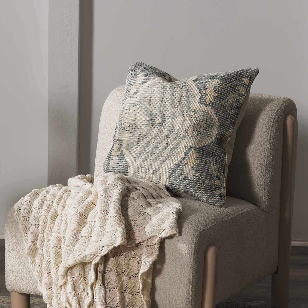 Woven Bigaa throw pillow cover in teal, gray, and peach traditional pattern on a sofa