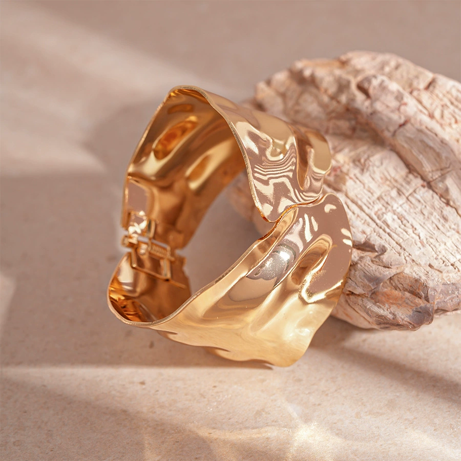 Gold sculpted cuff bracelet with bold contemporary design and smooth polished metallic finish — view 5