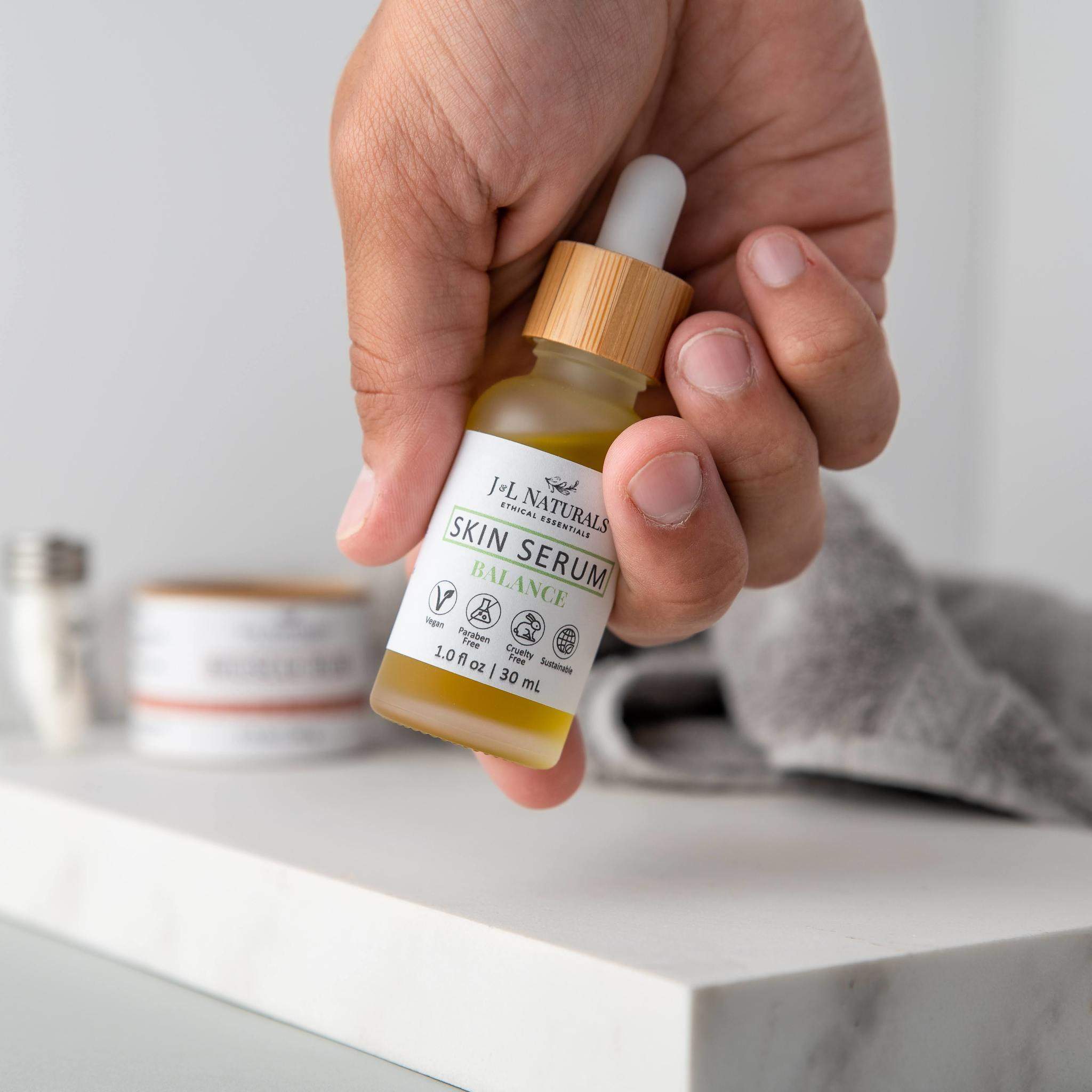 Natural plant-based face and body oil skin serum in a 1 oz glass dropper bottle
