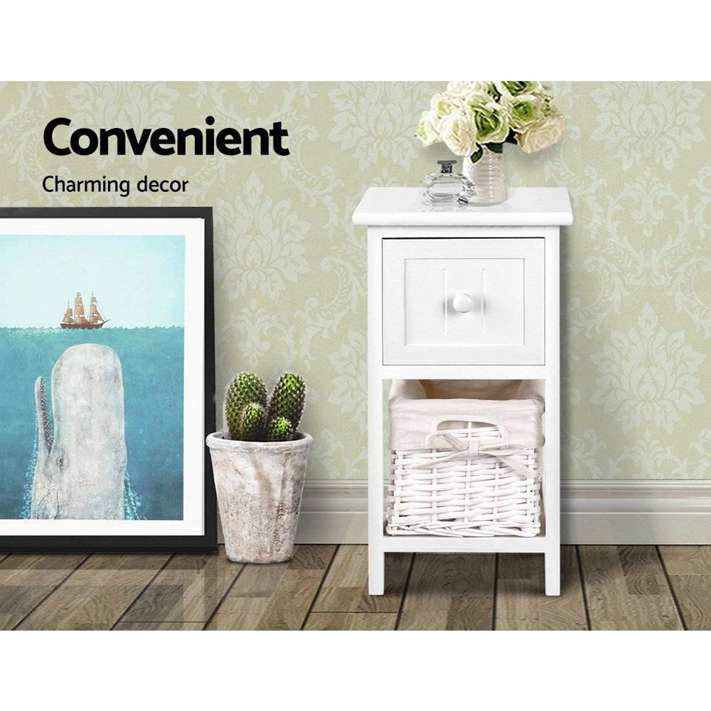 Two rustic white wood bedside tables with smooth top drawers and wicker storage baskets. — view 3