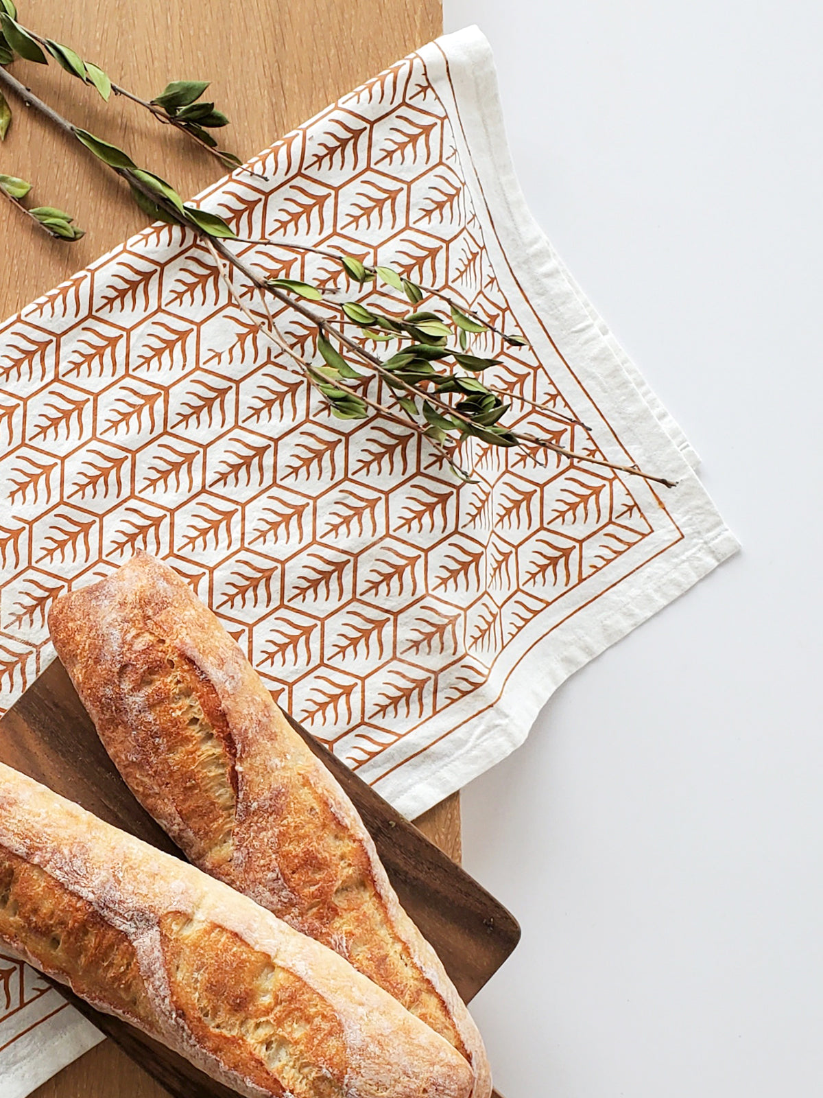 Hand screen-printed tea towel in natural white cotton with brown earthy artisan design patterns — view 3