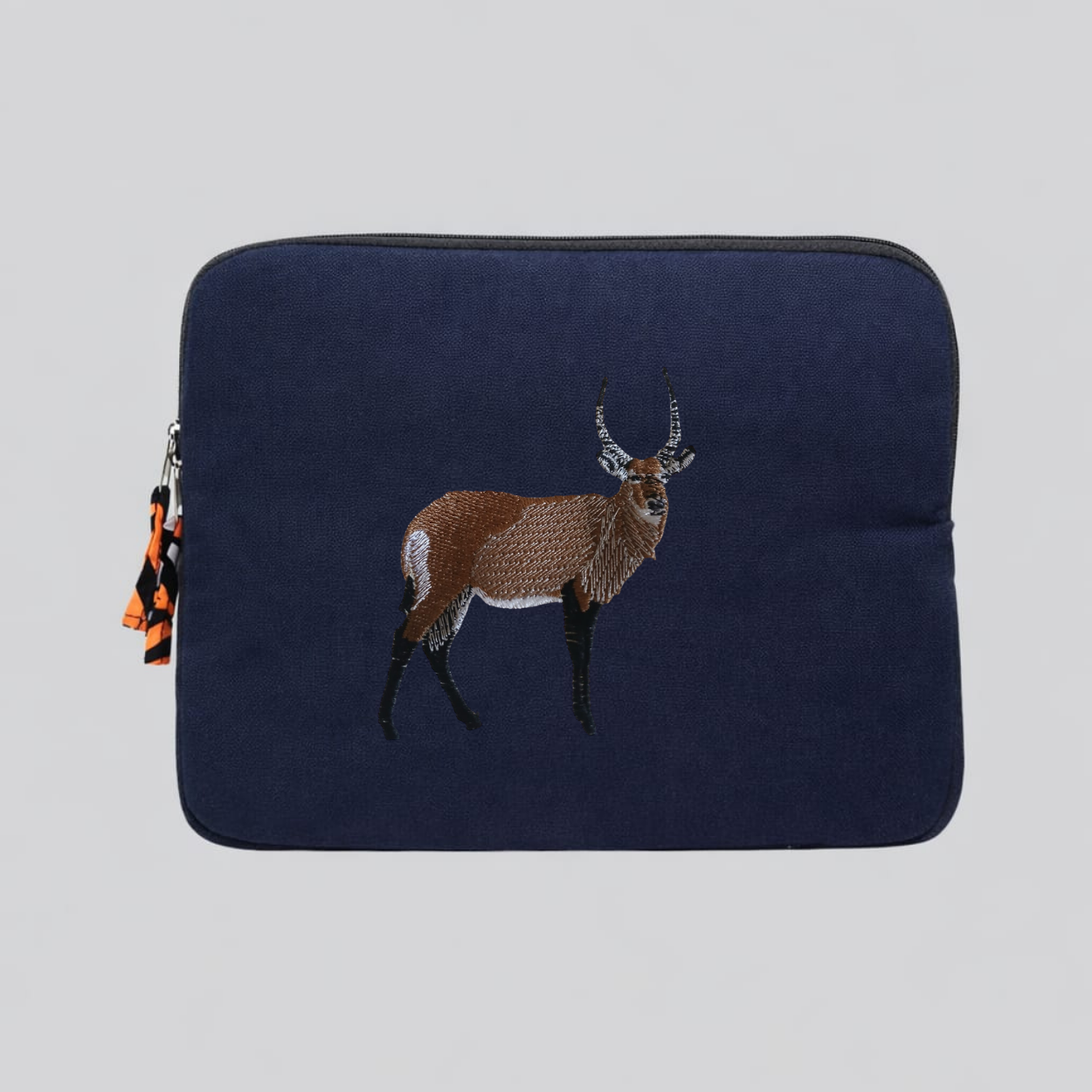 Handmade Kenyan cotton canvas laptop sleeve featuring embroidered African wildlife design in warm earthy tones — view 2