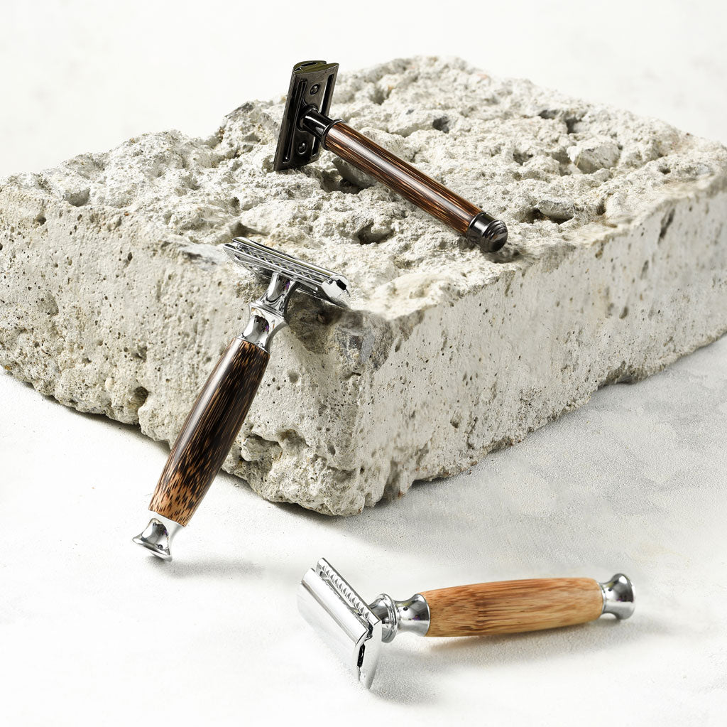 Reusable bamboo safety razor with long wooden handle and stainless steel head alongside kraft packaging — view 3