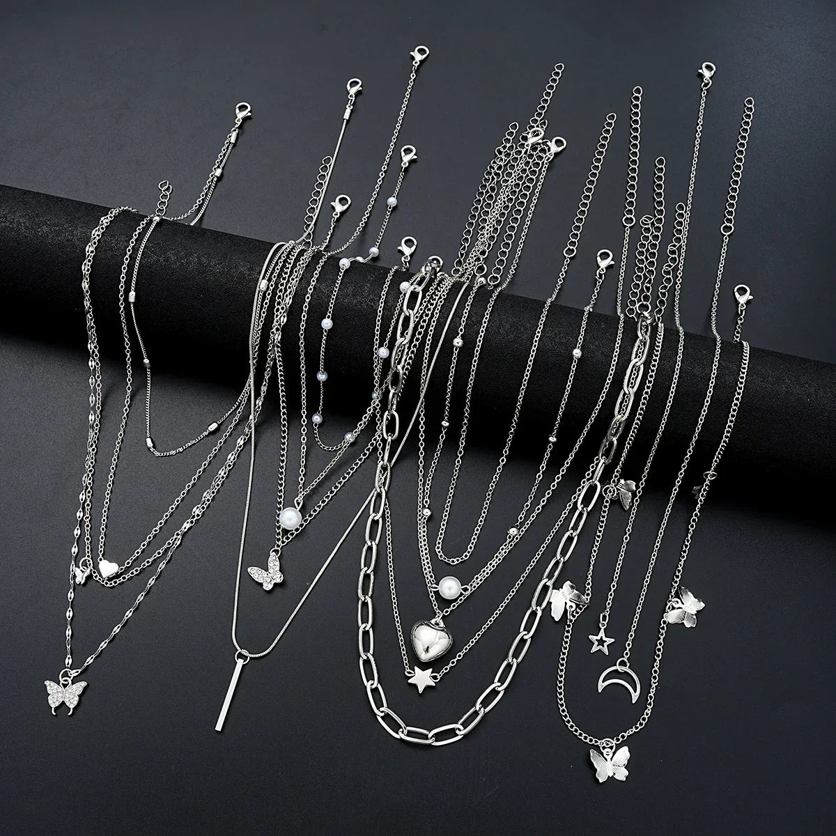 13-piece silver women's necklace set featuring heart, butterfly, pearl, and star charm pendants — view 2