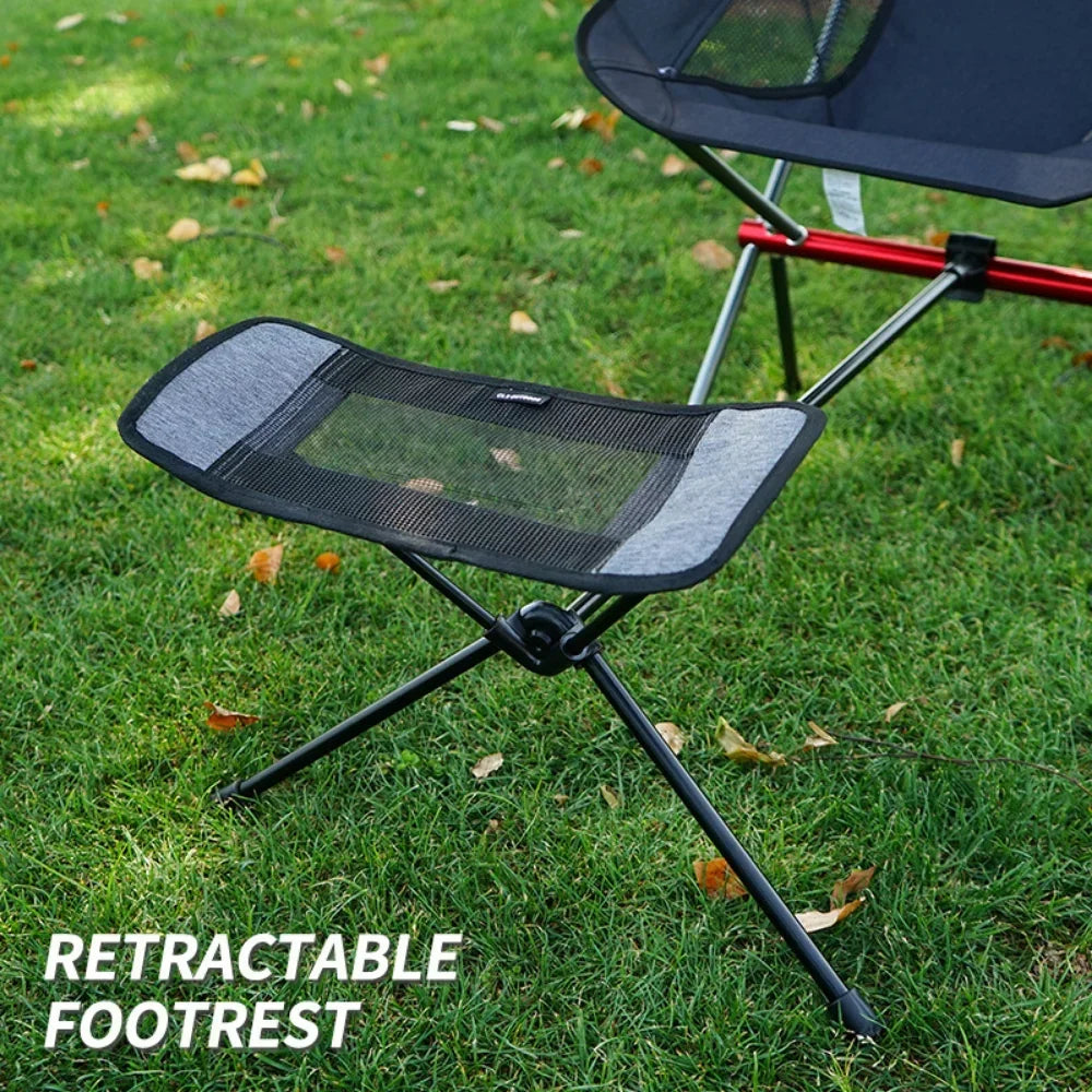Lightweight folding outdoor camping chair with foot recliner and aluminum frame in outdoor setting — view 4
