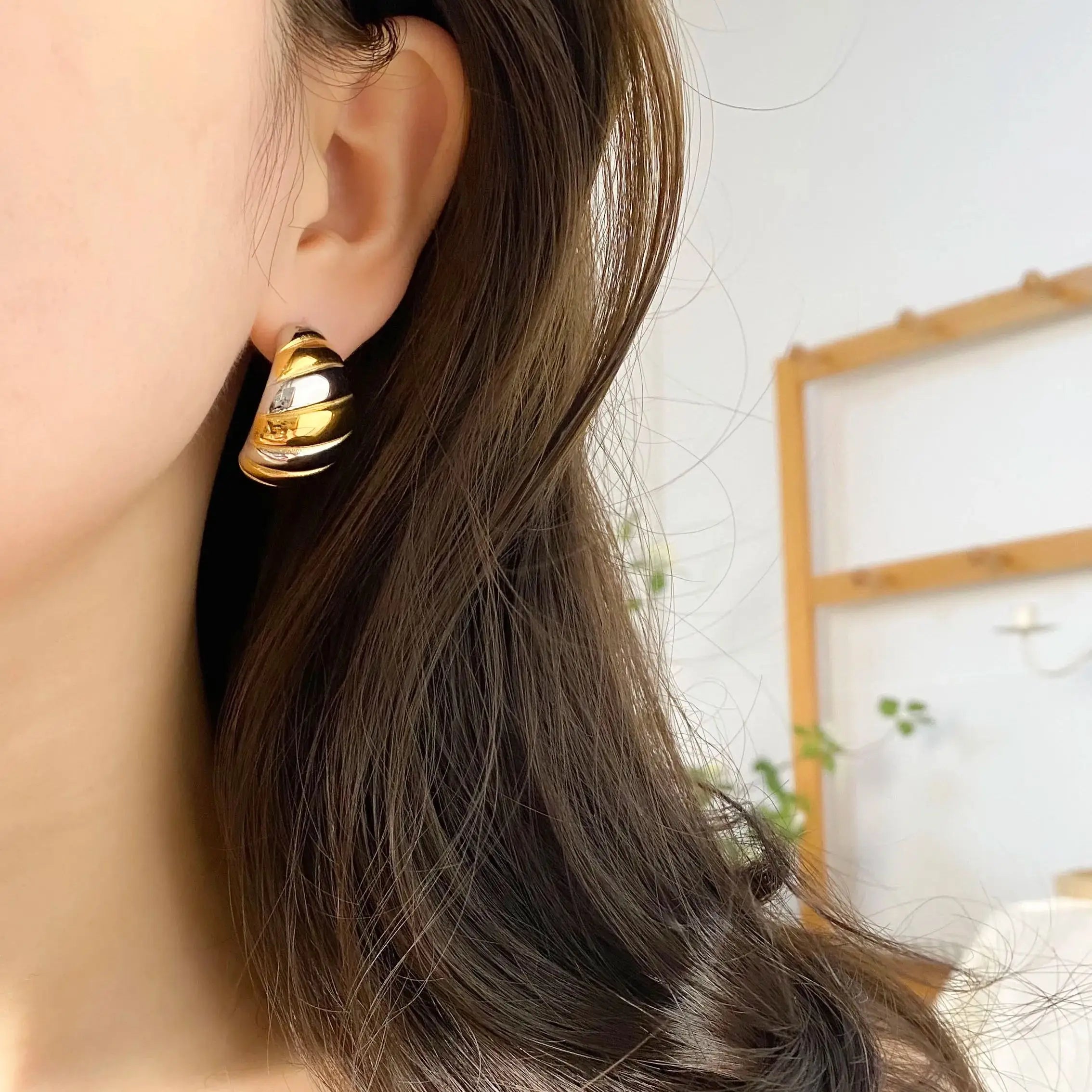 Gold plated geometric stud earrings made of hypoallergenic stainless steel on a clean background — view 2