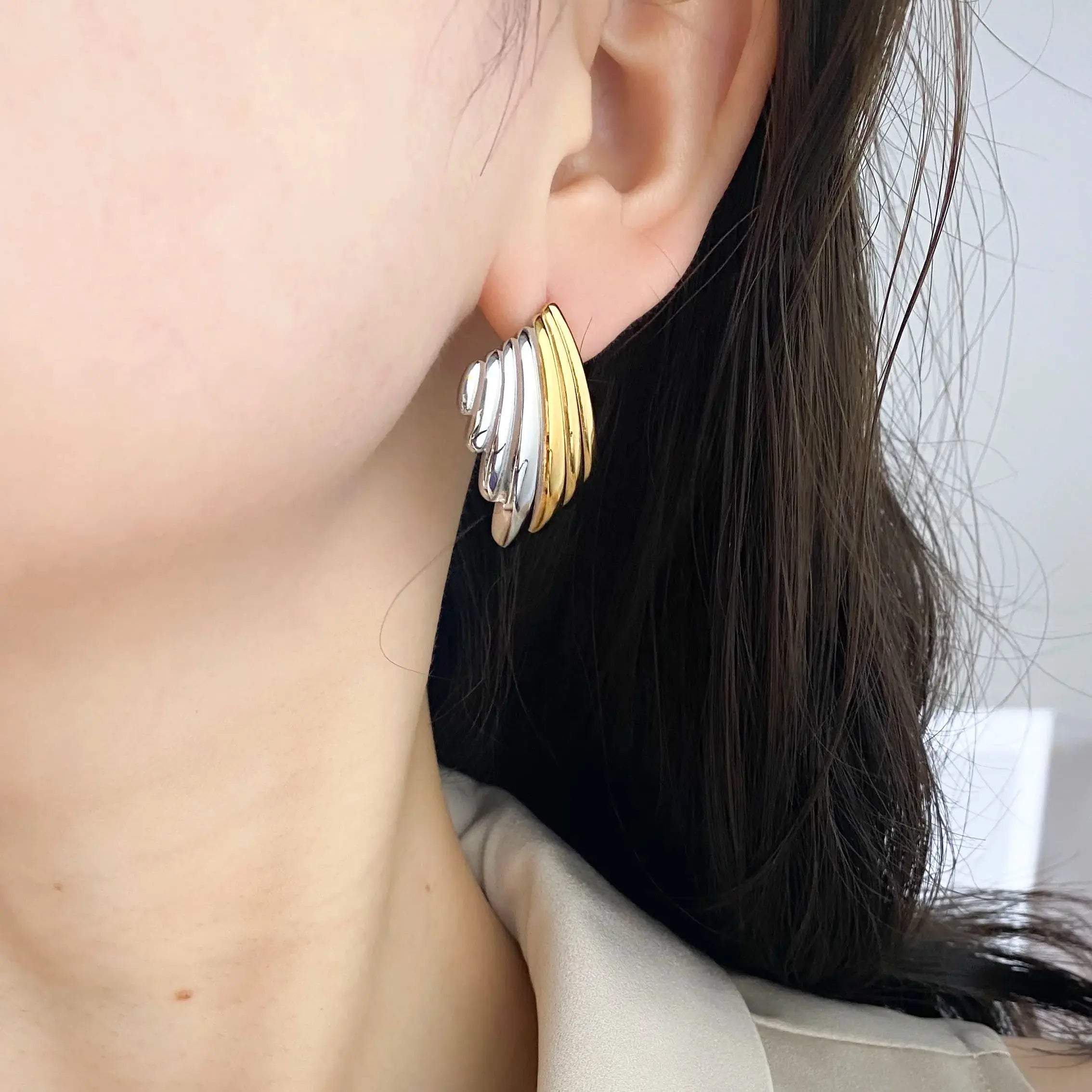 Gold plated geometric stud earrings made of hypoallergenic stainless steel on a clean background — view 4