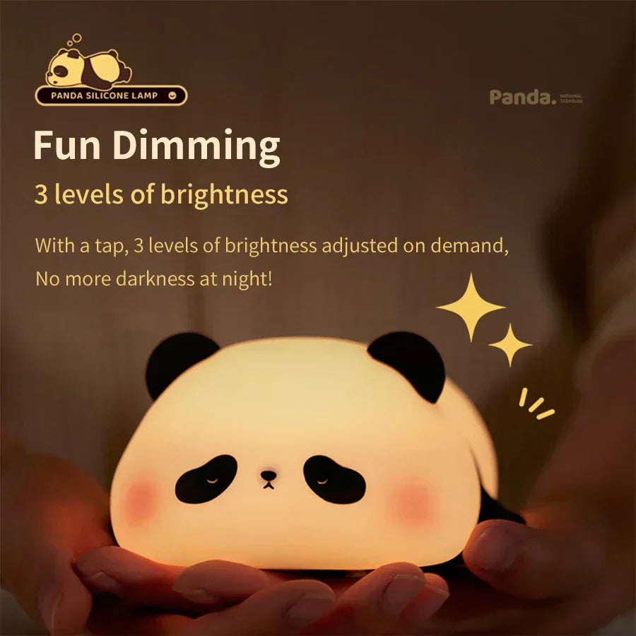 Cute panda silicone LED night light emitting a warm glow on a bedside table — view 3