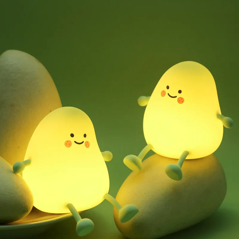 Cute mango night light made of soft silicone emitting a warm glow for bedside decor — view 2