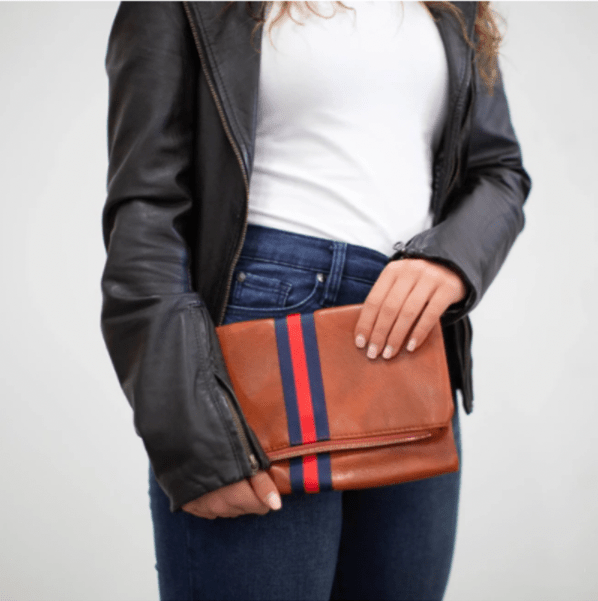 Vegan leather fold over clutch bag with accent stripe and removable braided woven shoulder strap — view 5