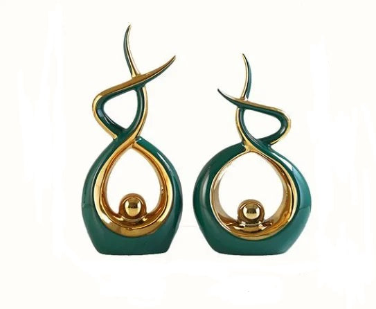 Set of two elegant green abstract resin sculpture statues displayed as modern home decor