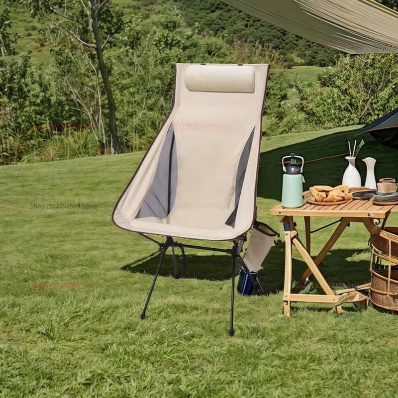 Beige portable folding camping chair with aluminum frame and ergonomic headrest on white background — view 2
