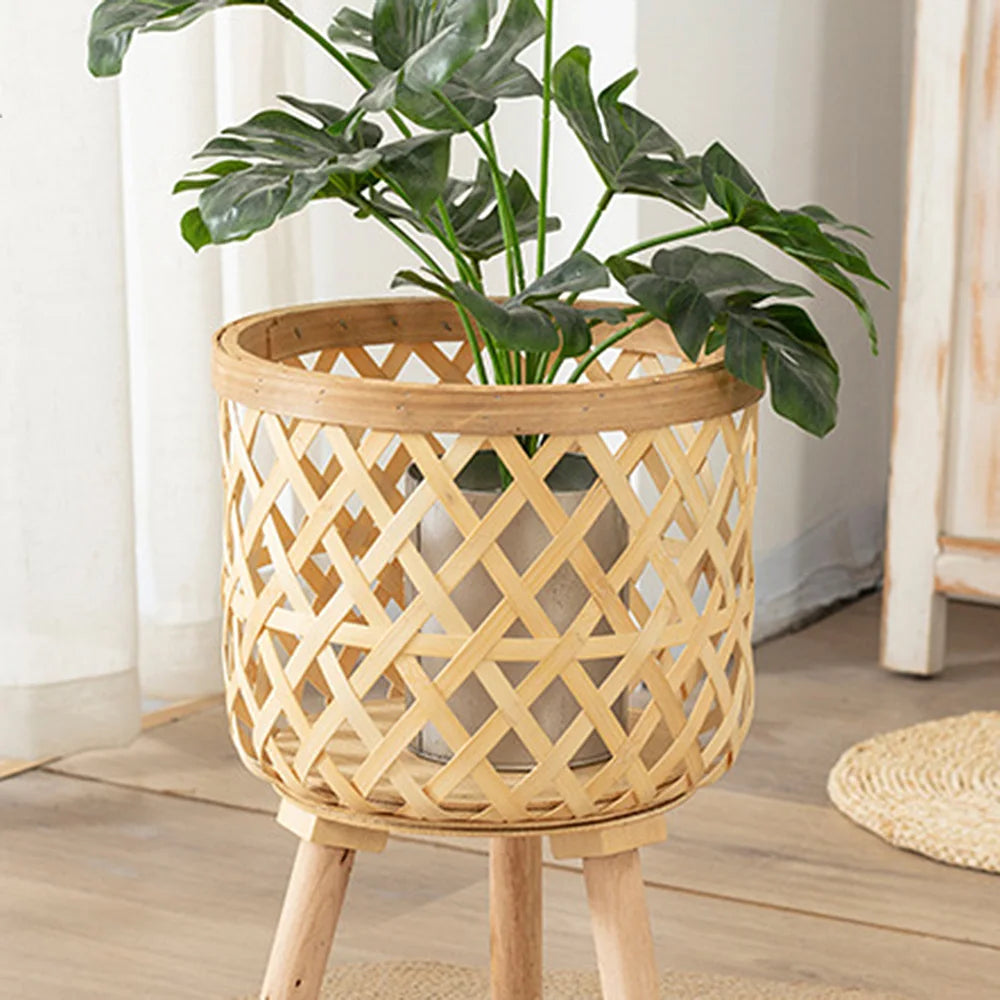 Handmade bamboo woven plant stand with elevated wooden base, displaying a potted green houseplant. — view 3