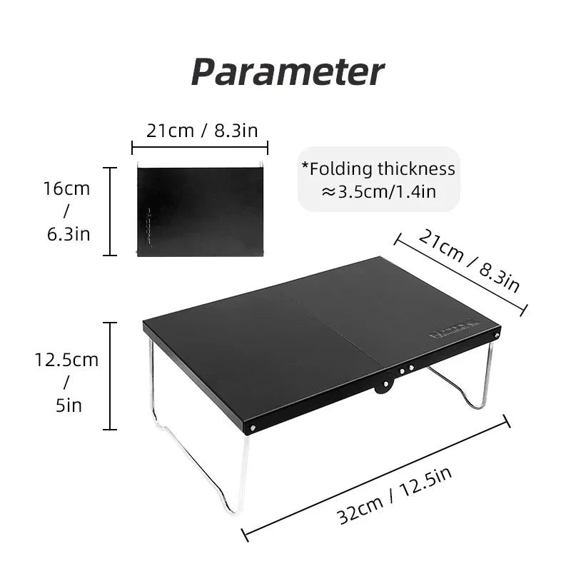 Black portable foldable camping table made of lightweight MDF, set up outdoors — view 4