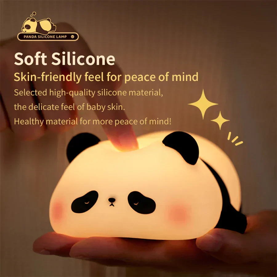 Cute panda silicone LED night light emitting a warm glow on a bedside table — view 2