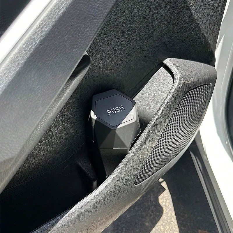 Portable mini car trash can in black with secure lid inside vehicle cup holder — view 3