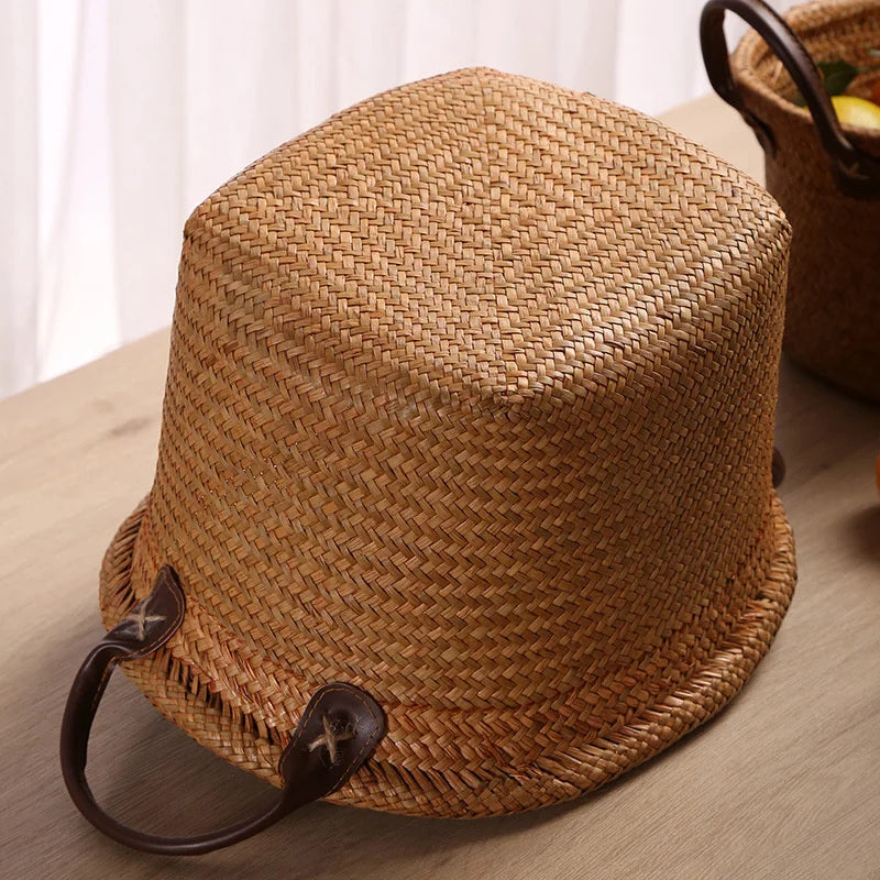 Foldable seagrass wicker basket with natural woven texture and elegant brown leather carrying handles — view 4