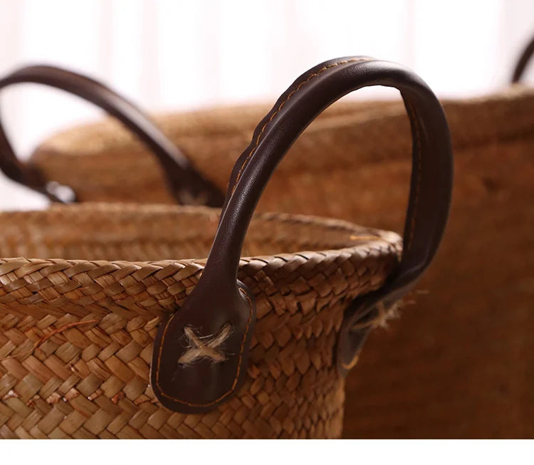 Foldable seagrass wicker basket with natural woven texture and elegant brown leather carrying handles — view 5