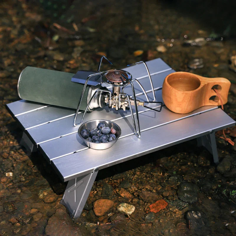 Foldable mini camping table in silver aluminum alloy set up outdoors for a picnic or barbecue — view 2