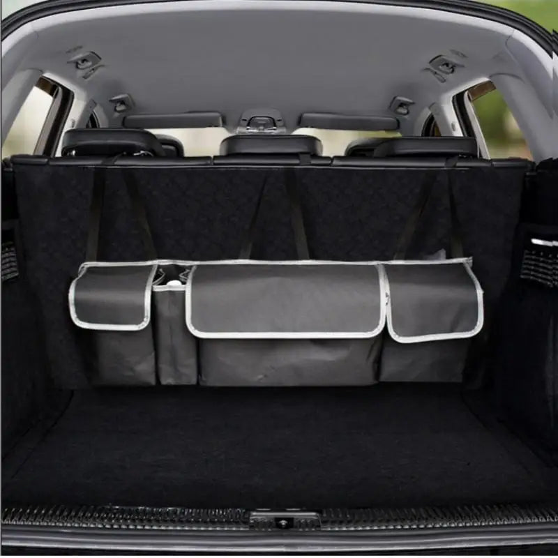 Black polyester car back seat organizer with multiple storage pockets hanging on a vehicle seat — view 2