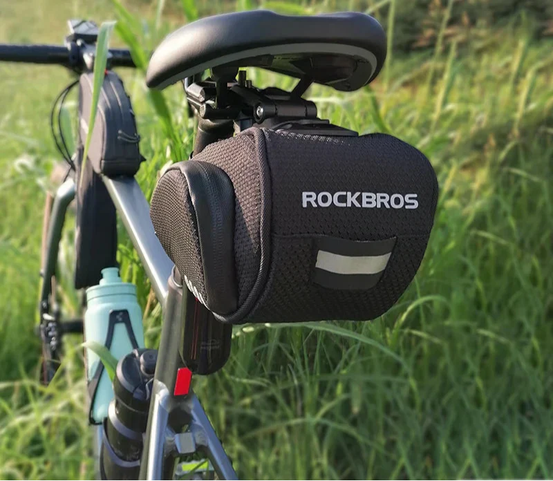 Black rainproof bike saddle bag featuring shockproof padding and quick release bracket mounted under bicycle seat — view 5