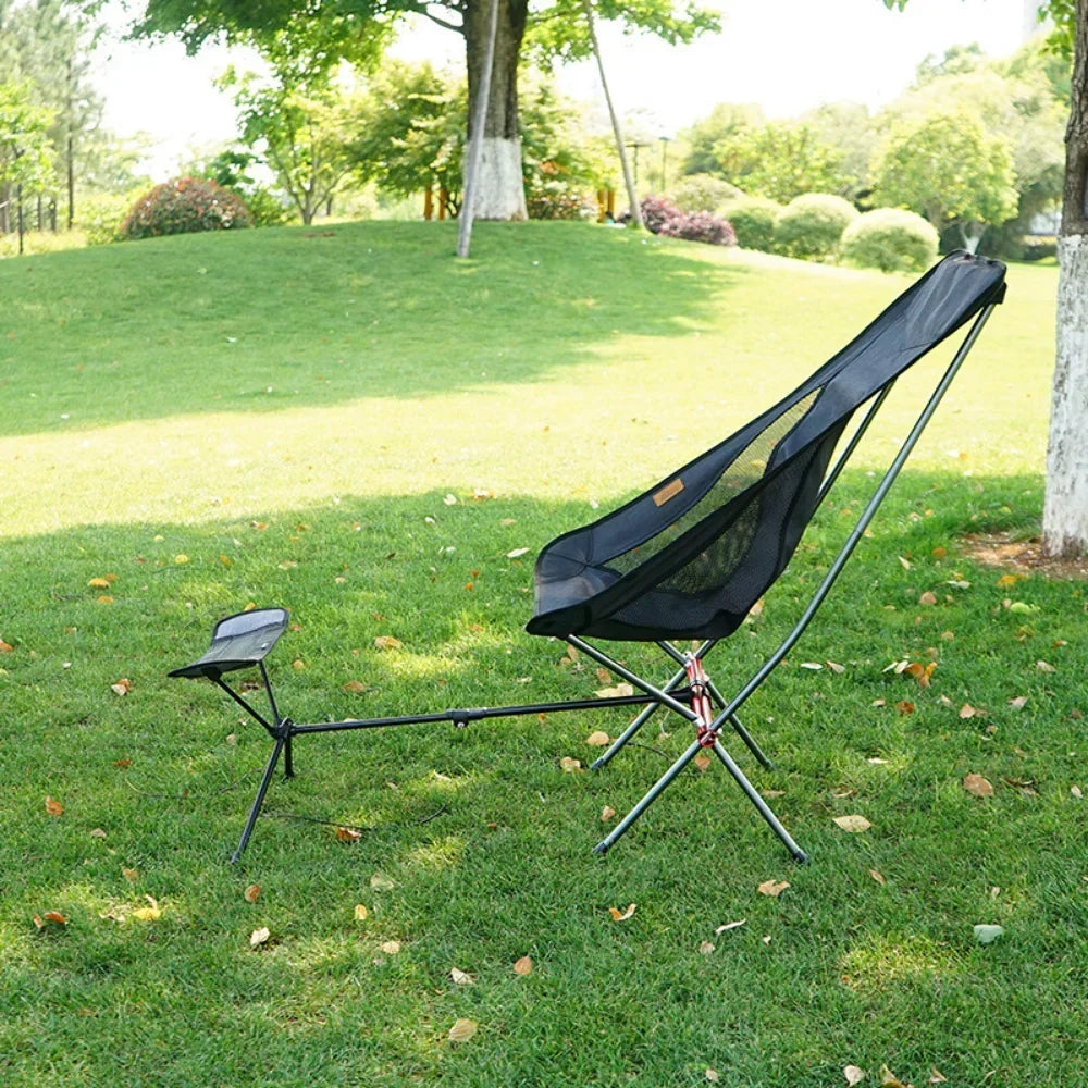 Lightweight folding outdoor camping chair with foot recliner and aluminum frame in outdoor setting — view 5