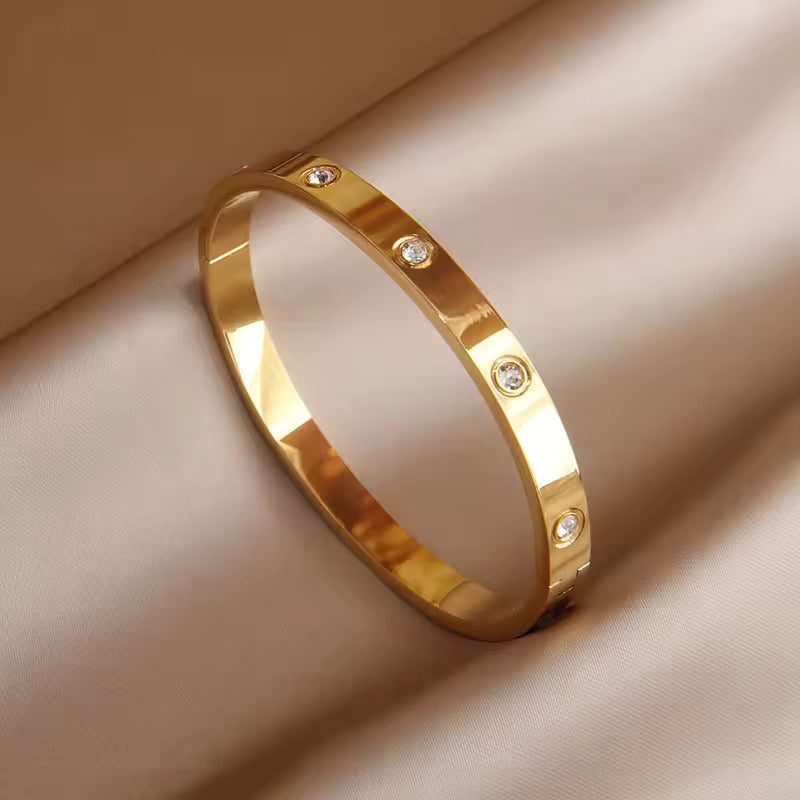 Crystal Love Bangle Bracelet with heart shaped crystal centerpiece and polished metallic adjustable band — view 4