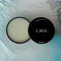 Speakeasy solid cologne in a compact travel tin, natural vegan men's fragrance balm.